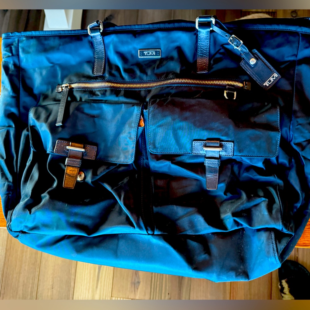 Tumi personal travel tote slips over luggage